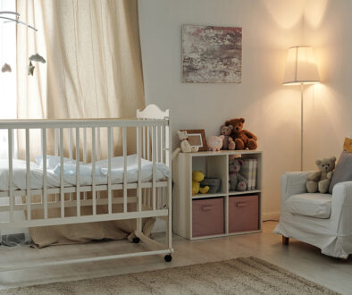 Interior of large contemporary room of baby with cradle and furniture
