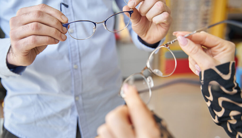 Glasses in hands of Caucasian woman and man