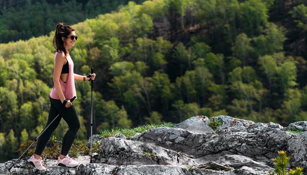 The traveler is happy to climb the mountain. Hiking in the mount