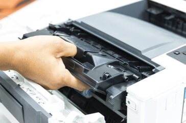 Technicians replacing toner in laser printer concept office supp