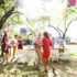 A senior couple dancing on a garden party outside in the backyard.